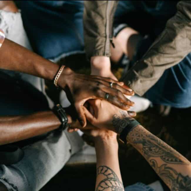 Group Of People With Tattoos High Fiving