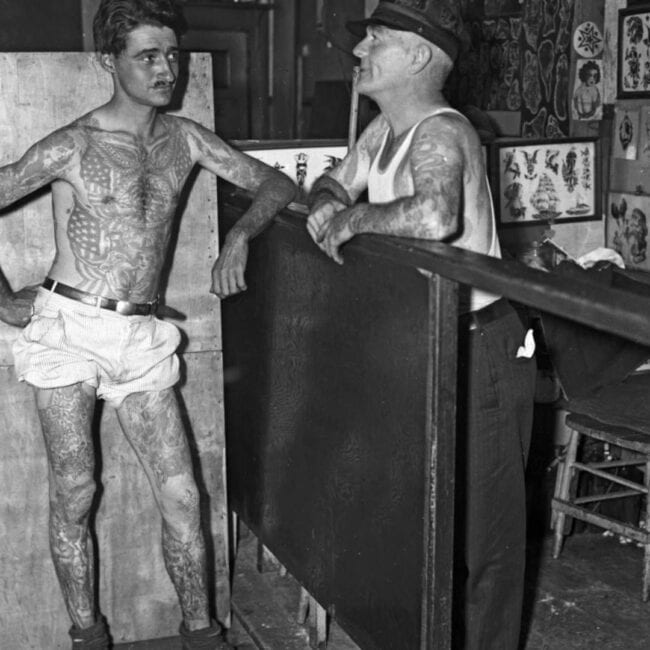 Black and White Old Photo Two Tattooed Men Talking in the Tattoo Studio