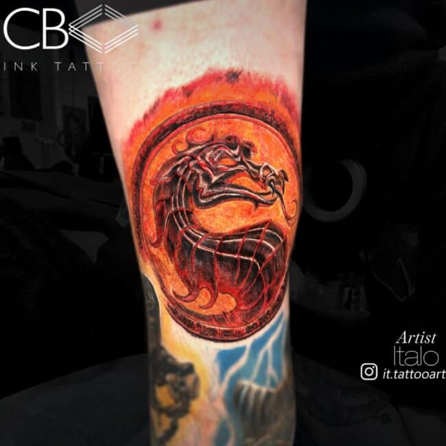 Italo Tattoo Artist Realism Cartoon Colour Mortal Kombat Logo Black Dragon in Fire Circle Leg Tattoo