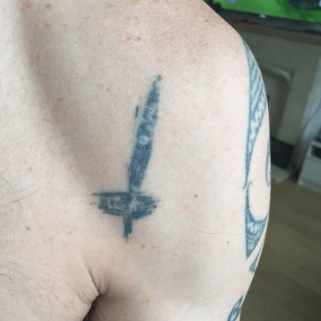Steve-O Black and White Upside Down Cross Arm Tattoo