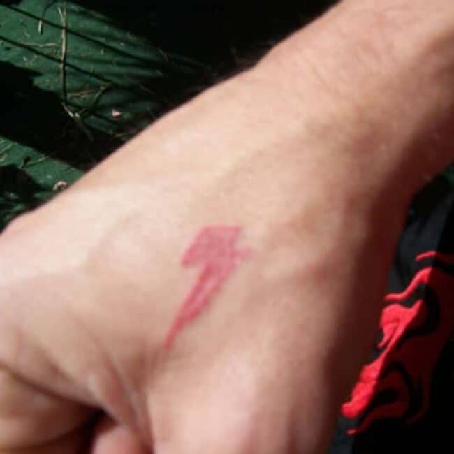 Steve-O Red Colour Lightning Bolt Hand Tattoo