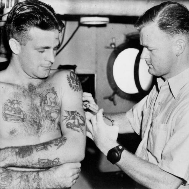Australian Sailor Covered in Travel Tattoos Getting Another Tattoo Black and White Photo