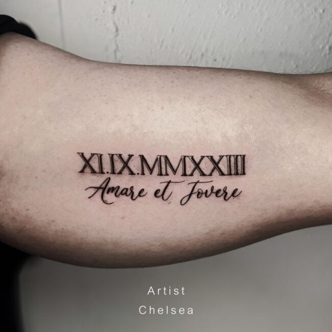 Chelsea Tattoo Artist Script Lettering Black and Grey XIIXMMXXIII Amare et Fovere Arm Tattoo