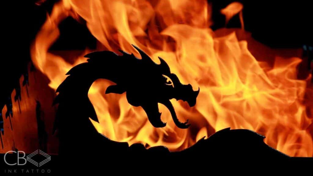 Dragon Silhouette Fire In The Background Unleash the Beast Brisbane’s Most Incredible Dragon Tattoos Blog Cover Image