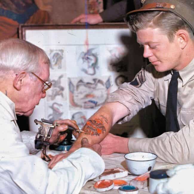 George Burchett Tattooing a U.S. Army Soldier in London, 1943, Photo