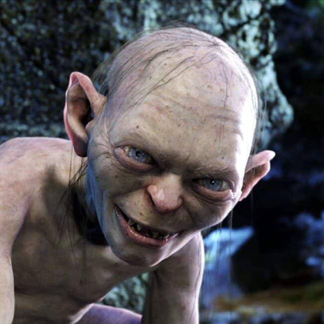 Gollum Smiling in Cave Blue Eyes Minimal Hair Big Ears Portrait Image from The Lord of The Rings Movie