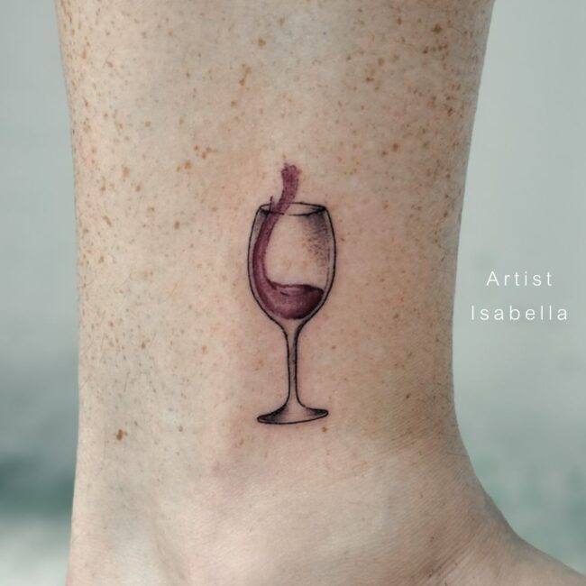 Isabella Tattoo Artist Fine Line Colour Red Wine Splashing in See Through Wine Glass Forearm Tattoo