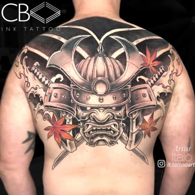 Italo Tattoo Artist Japanese Traditional Black and Grey Colour Samurai Helmet with Orange Leaves Around Crossed Katanas and Full Black Line Patterns Back tattoo