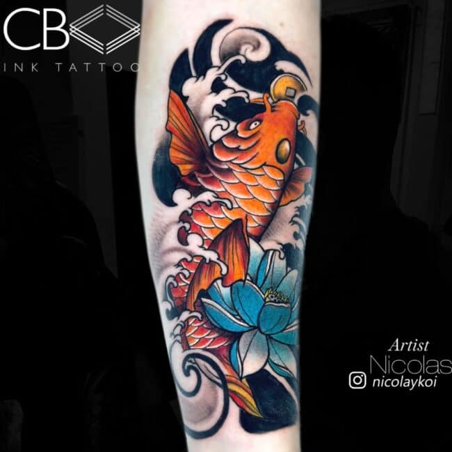 Nicolas Tattoo Artist Japanes Colour Orange Fish From Top View Blue Flowers Colourful and Black Ornaments Forearm Tattoo