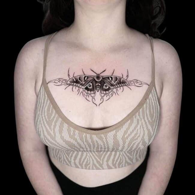 Penno Tattoo Artist Chicano Black and Grey Detailed Butterfly with Sharp Abstract Elements Background Sternum Tattoo