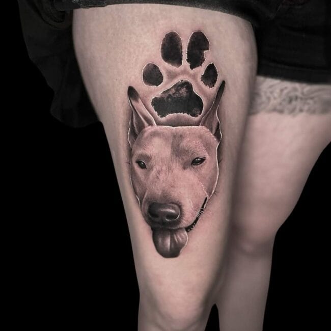 Penno Tattoo Artist Realism Portrait Black and White Dog Tongue Out Paw Print Above Thigh Tattoo