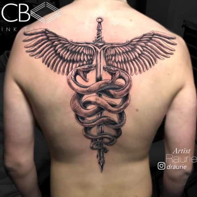Raurie Tattoo Artist Realism Black and Grey Detailed Caduceus Sword Angel Wings Two Snakes Hissing Back Tattoo