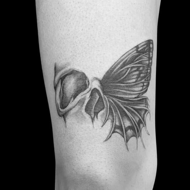 Riana Tattoo Artist Black and Grey Realism Half Skull Eye Socket Nose Half Detailed Butterfly Wings Thigh Leg Tattoo