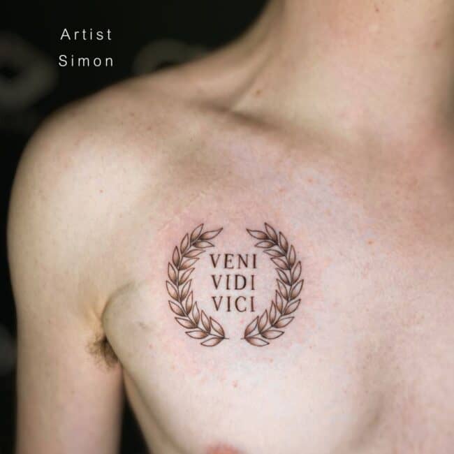 Simon Tattoo Artist Fine Line Black and Grey Writing Veni Vidi Vici Detailed laurel Circle Chest Tattoo