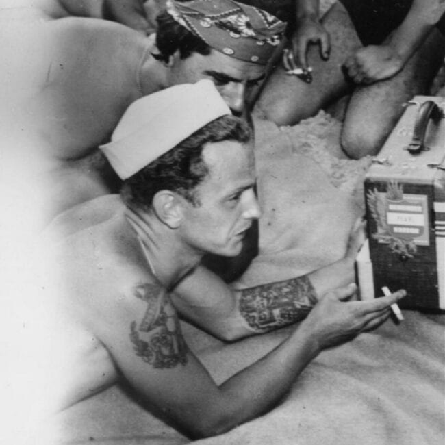 Soldiers Listening to Baseball at Coney Island Beach Radio While Showing Arm Tattoos Black and White Photo