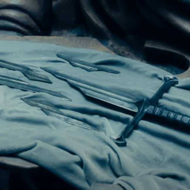The Narsil Sword Broken In Pieces Laying on a Piece of Cloth Image from The Lord of The Rings Movie