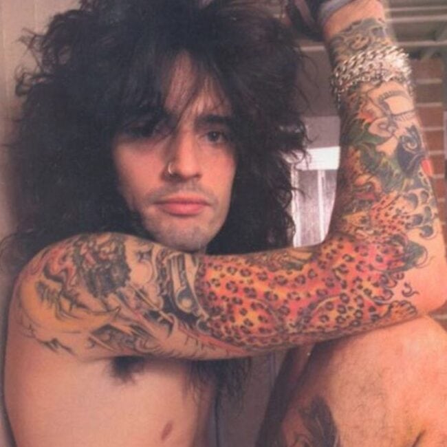 Tommy Lee Sitting Nude Showing Off His Arm and Leg Tattoos Photo