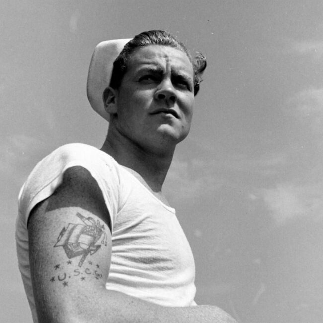 U.S. Coast Guard Showing His American Flag Arm Tattoo Black and white Photo