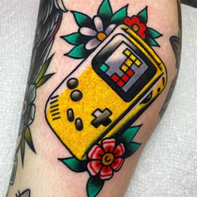 Colour Neo Traditional Yellow Game Boy with Floral Traditional Patterns Forearm Tattoo