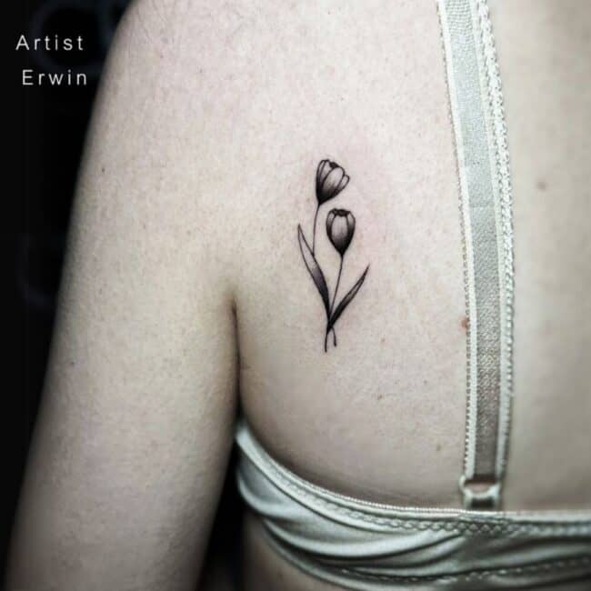 Erwin Tattoo Artist Black and Grey Delicate Floral Sprig Soft Petals Leaves Shoulder Back Tattoo