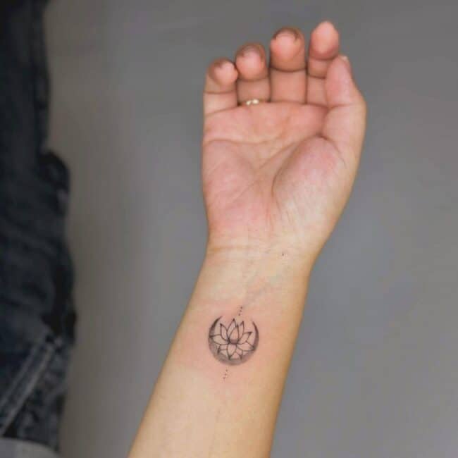 Fine Line Minimalist Lotus Flower With Three Dots Above and below Forearm Wrist Tattoo