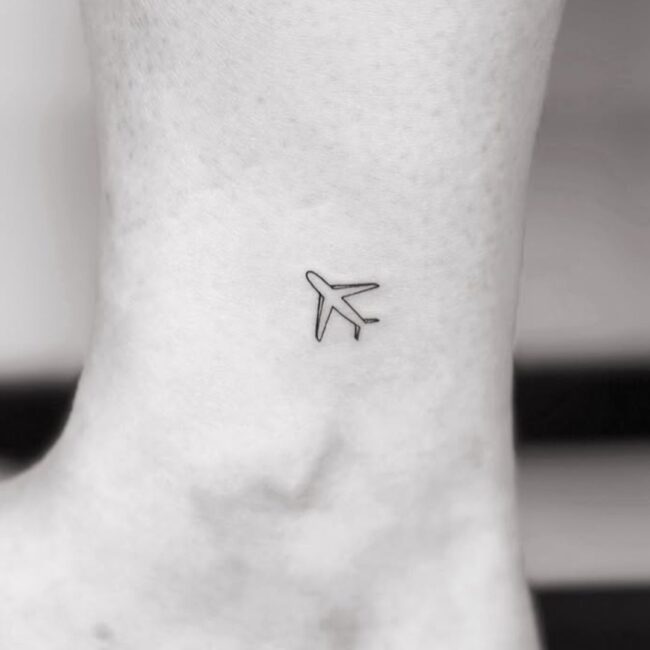 Fine Line Small Airplane Ankle Tattoo