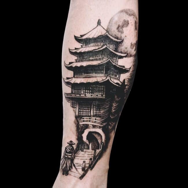 Juan Tattoo Artist Japanese Black and Grey Realism Samurai Standing in front of Old Japanese Building with Moon in the Background Forearm Tattoo