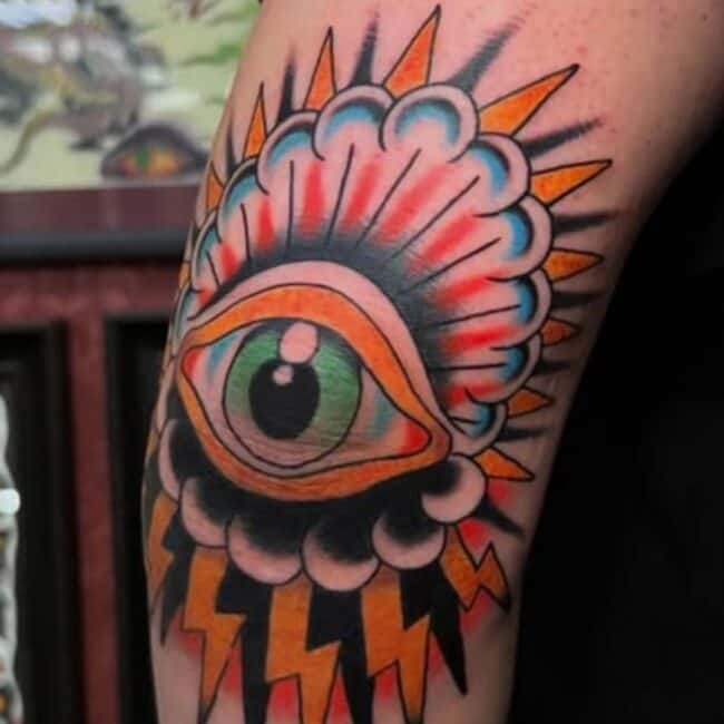Traditional Colour All Seeing Eye Striking Lightning Sharp Shadows Symbolic Elbow Tattoo