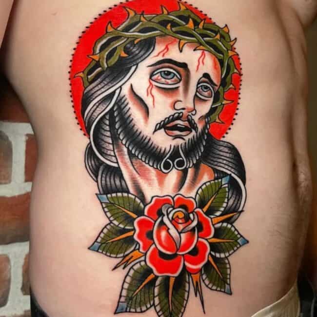 Traditional Colour Detailed Jesus Christ Portrait Floral Patterns Fiery Halo Crown Of Thorns Rib Side Tattoo