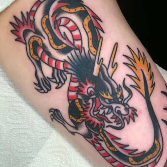Traditional Colour Roaring Coiling Dragon Distinctive Horns Tail Talons Arm Tattoo
