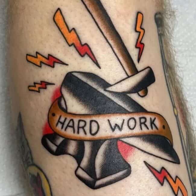 Traditional Colour Script Lettering Anvil and Hammer Lightning Bolts Writing of Hard Work Forearm Tattoo