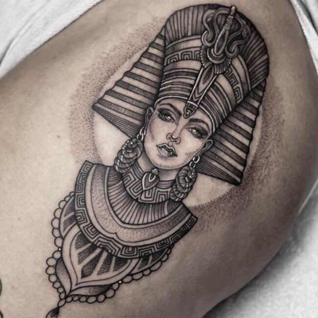 Black and Grey Realism Fineline Geometric Mandala Dotwork Cleopatra Portrait Ancient Egyptian Symbol Detailed Eyes Nose Lips Headdress Ancient Necklace Earrings Upper Shoulder Arm Tattoo