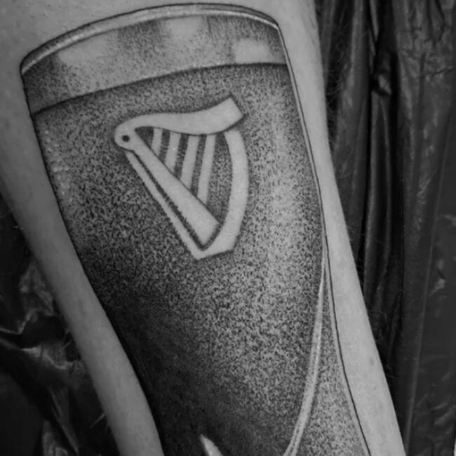 Black and Grey Realism Guinness Beer Logo Glass Dots Bubbles Lines Forearm Tattoo