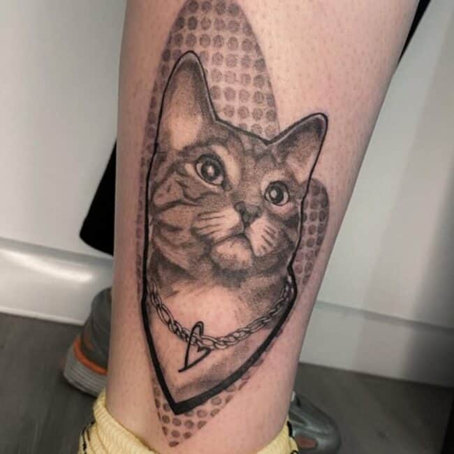 Black and Grey Realism Portrait Cat Detailed Eyes Ears Nose Mouth Necklace with Heart Dots Abstract Background Side Leg Calf Tattoo