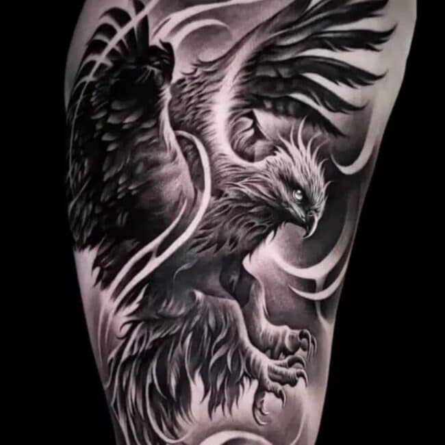 Black and Grey Realism Whole Body Phoenix Pointed Beak Glowing Eye Crest Wings Tail Sharp Talons Nails Leg Feet Detailed Wind Feathers Shoulder Arm Tattoo