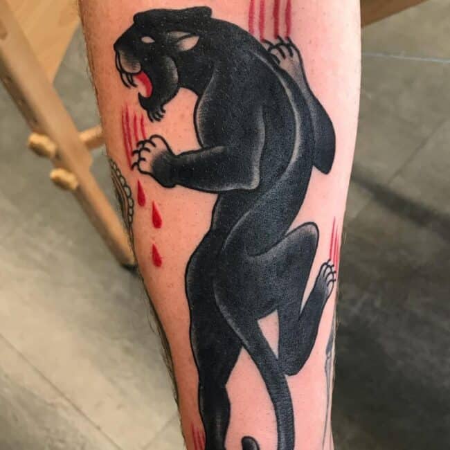 Blackwork Black and Grey Sailor Jerry Whole Black Panther Sea Fierce Eyes Whiskers Nose Ears Sharp Teeth Red Scratches Forearm Tattoo