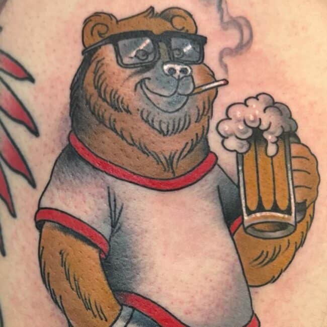 Colour Cartoon Playful Bear Holding a Beer Cigarette Hand on Pocket Short Shirt Eye Glasses Smoke Nose Lips Ears Eyes Shoulder Arm Tattoo