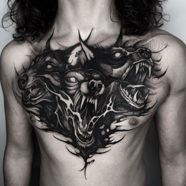 Black and Grey Blackwork Realism Cerberus Three Headed Dog Sharp Teeth Bared Fur Intricate Lines Monstrous Hound Chest Tattoo