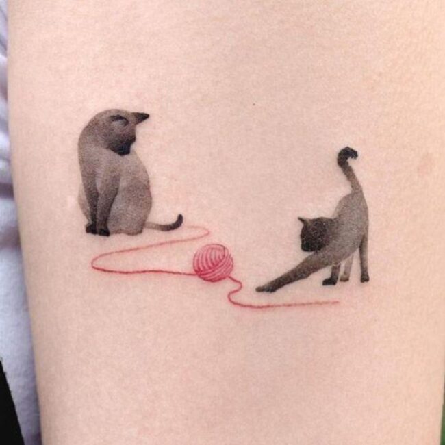 Fine Line Minimalist Two Cats Siamese Playing Sitting Stretching with Ball of Yarn Red Forearm Tattoo