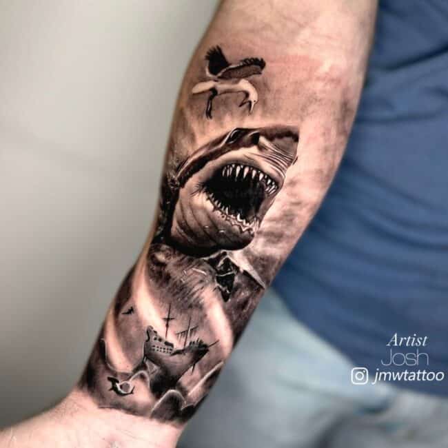 Josh Tattoo Artist Black and Grey Realism Large Open Mouth Shark Sharp Teeth Shocked Flying Bird Wide Wings Heavy Waves Rain Drifting Ship Forearm Tattoo