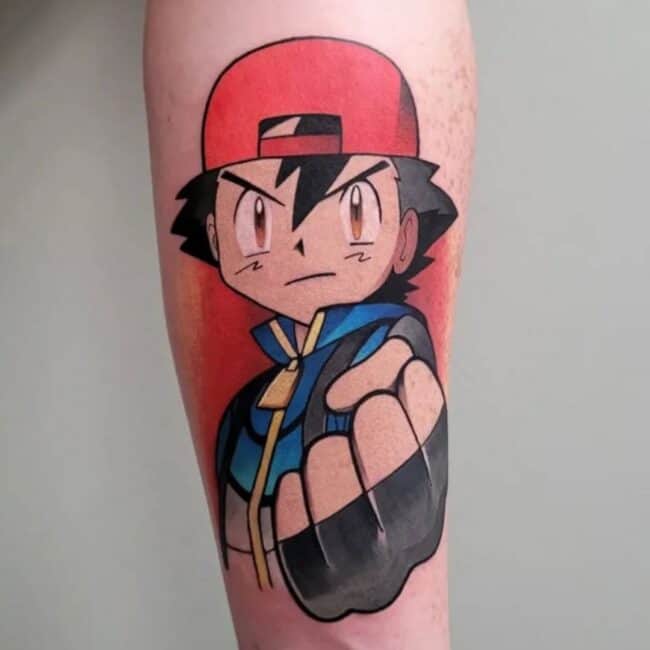 Neo Traditional Colour Anime Cartoon Portrait Ash Ketchum Serious Eyes Looking Straight with Red Cap Jacket Black Spiky Hair Clinched Hand Pointing Forward Forearm Tattoo