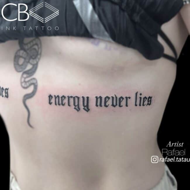 Rafael Tattoo Artist Script Lettering Blackwork Blackletter Font Text 'Energy Never Lies' Sternum Rib Tattoo