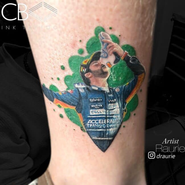 Raurie Tattoo Artist Realism Color Script Lettering Man Drinking on His Shoes Cap Jacket Eyes Beard Hands Mouth Watch Green Background Calf Leg Ankle Tattoo