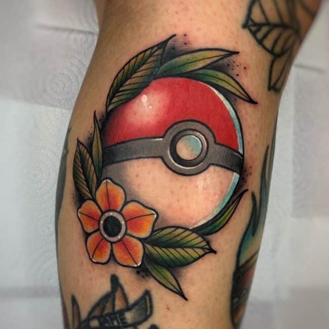 Traditional Colour Anime Cartoon Pokeball Detailed Central Silver Button with Flower and Leaves Arm Tattoo