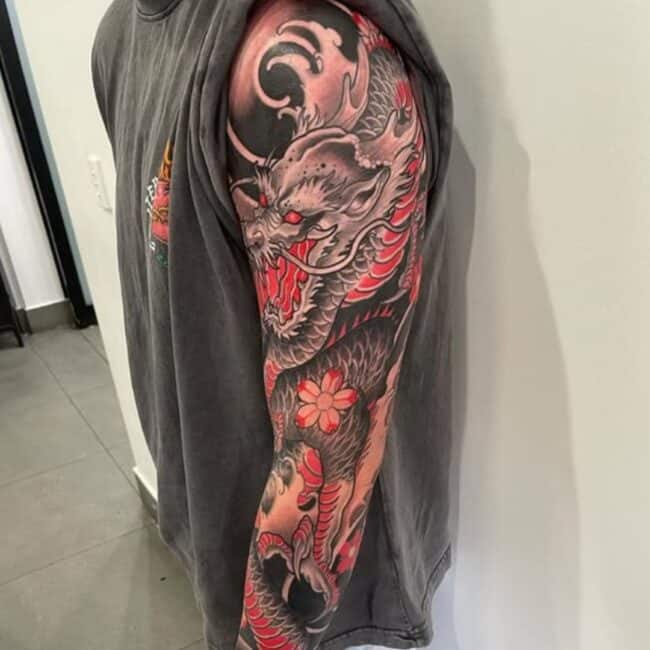 Traditional Japanese Colour Realism Dragon Sharp Teeth Horns Paws Claws Nose Red Eyes Waves Floral Elements Arm Sleeve Tattoo