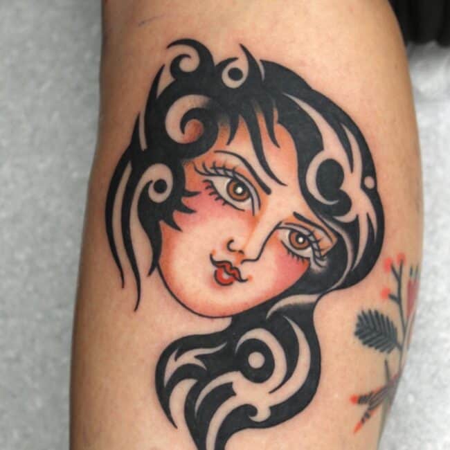 Tribal Traditional Colour Geometric Sharp Edges Thick and Thin Bold Line Patterns Curved Flow Detailed Womans Hair Eyes Nose Lips Forearm Tattoo