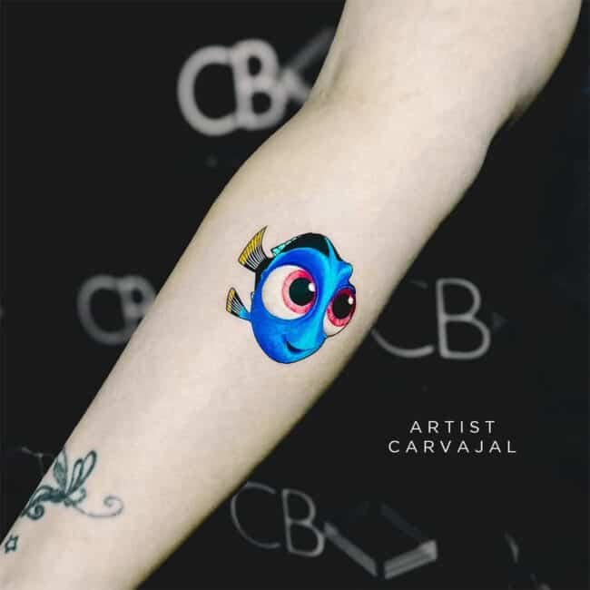 Carvajal Tattoo Artist Cartoon Color Minimalist Whole Body Baby Dory Blue Tang Fish Detailed Big Eyes Mouth Fins Head Forearm Tattoo