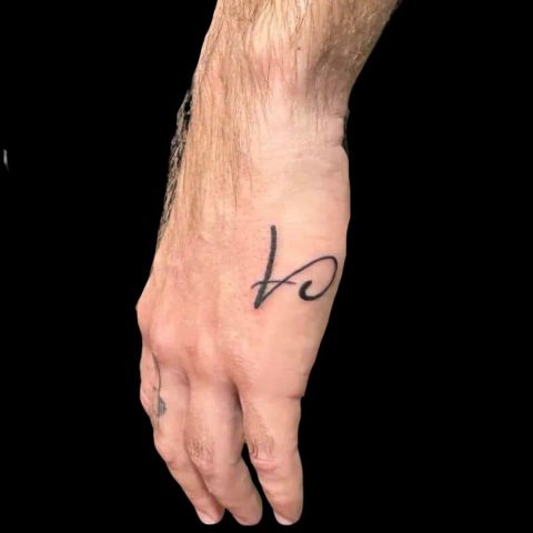 Small Lettering Hand Tattoo